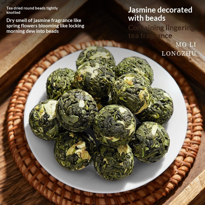 A plate of green tea-dried round beads, styled on a woven tray with promotional text overlays describing their scent and origin.