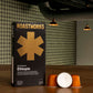 Roastworks coffee capsule packaging on a wooden surface with a blurred background