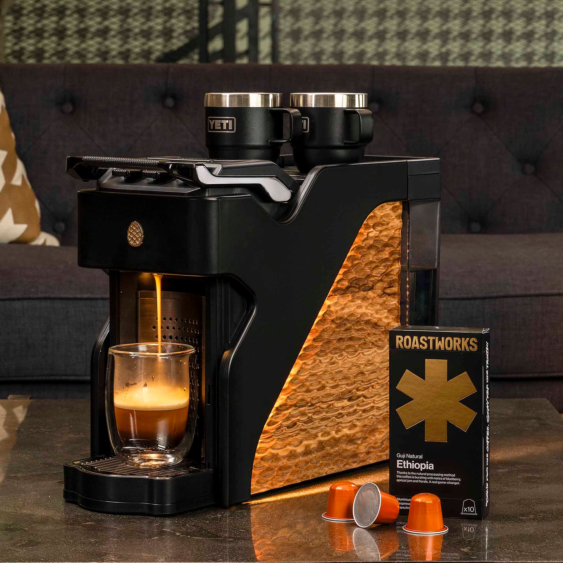 Coffee machine with a glass of coffee and Roastworks Ethiopia coffee package on a table.